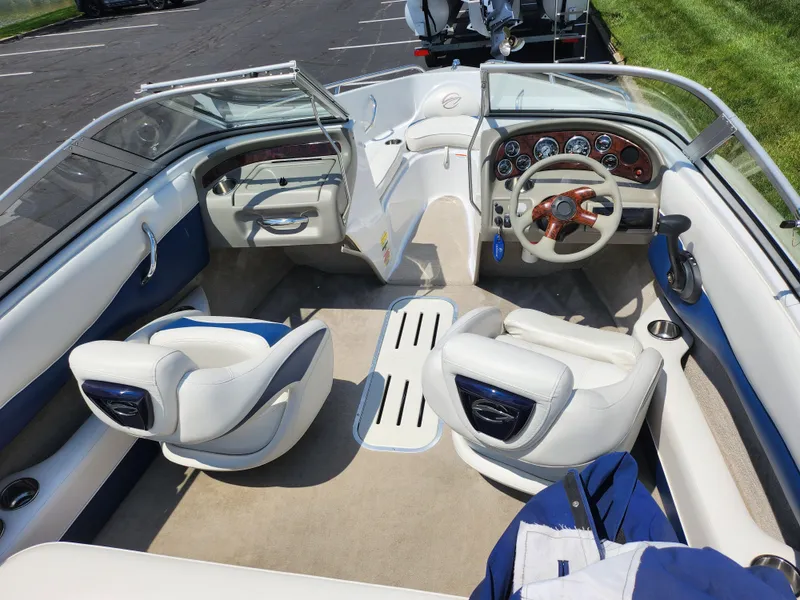 Slide: The Image of 2008 Crownline 180 BR boat interior with white seating and dashboard view. - 10