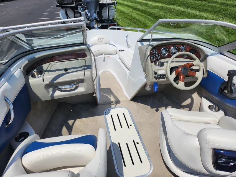Slide: The Image of 2008 Crownline 180 BR boat interior with steering wheel, seating, and dashboard. - 11