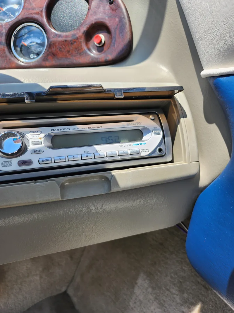 Slide: The Image of 2008 Crownline 180 BR dashboard with stereo system and wood grain accents. - 17