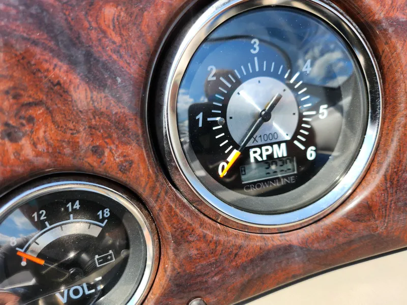 Slide: The Image of Close-up of 2008 Crownline 180 BR boat dashboard with RPM and voltage gauges. - 18