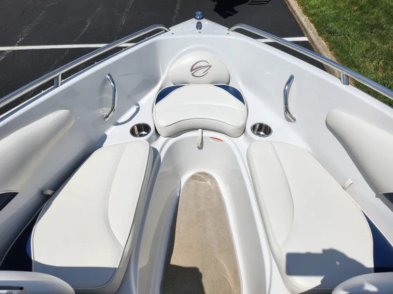 Slide: The Image of 2008 Crownline 180 BR boat interior with white seating and cup holders. - 19