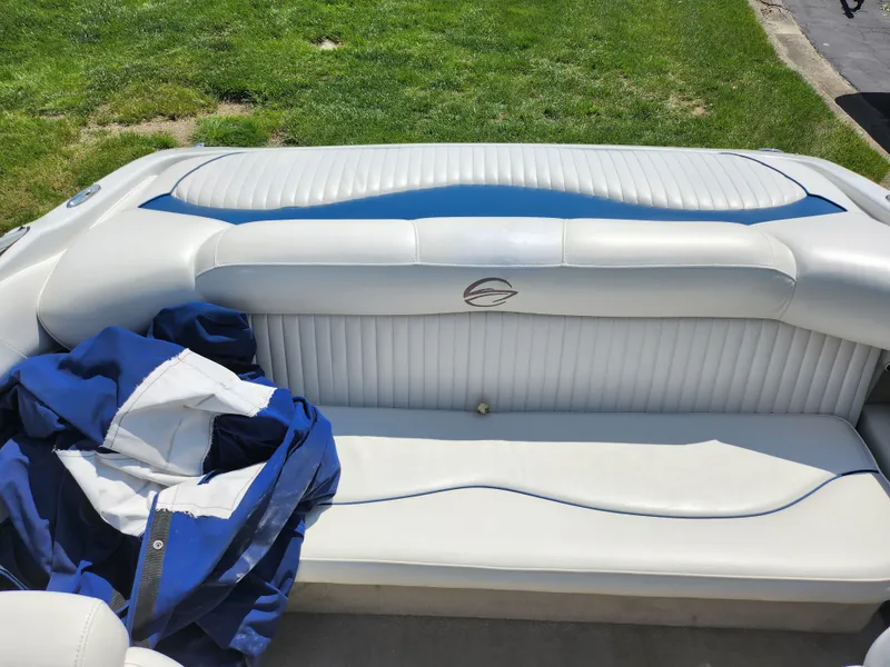 Slide: The Image of 2008 Crownline 180 BR boat interior with white seating and blue jacket. - 23
