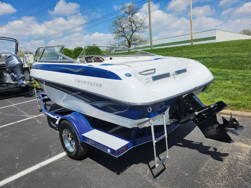 Slide: The Image of 2008 Crownline 180 BR boat on trailer, parked outdoors under a blue sky. - 3