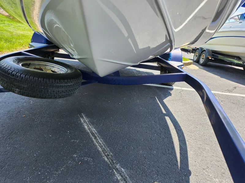 Slide: The Image of 2008 Crownline 180 BR boat on trailer, close-up view of hull and wheel. - 7