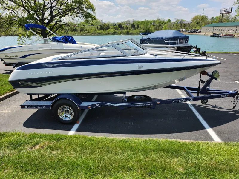 Slide: The Image of 2008 Crownline 180 BR boat on trailer by a lake, sunny day. - 9