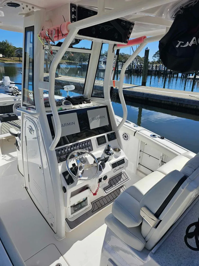 Slide: The Image of 2025 Tidewater 272 CC Adventure boat cockpit with modern navigation equipment and comfortable seating. - 5