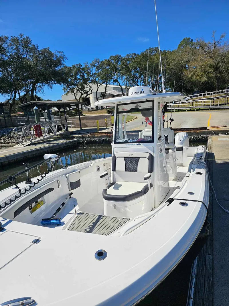 Slide: The Image of 2025 Tidewater 272 CC Adventure boat docked under clear blue sky. - 8