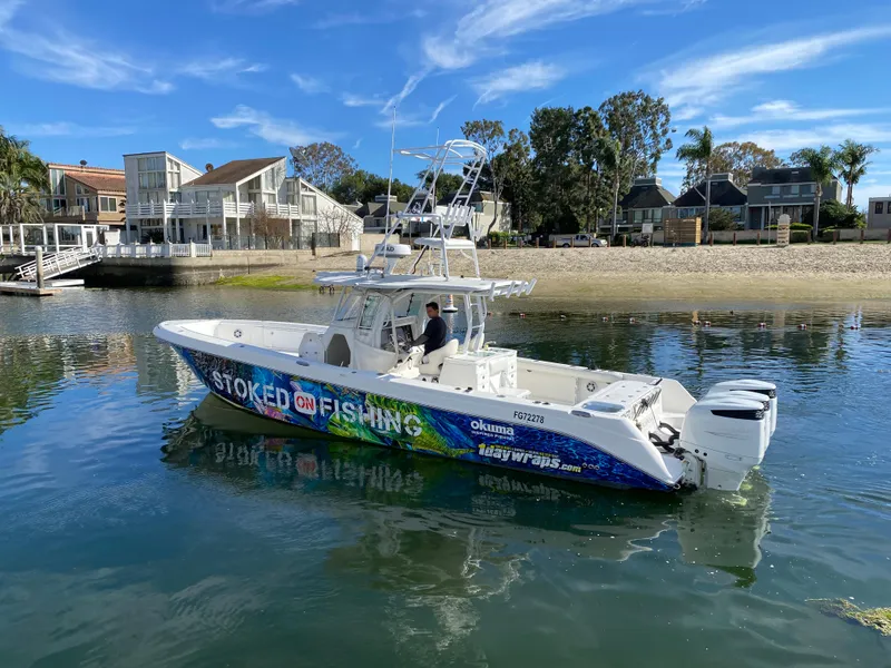 Slide: The Image of 2008 Everglades 355 Center Console boat on calm water near a sandy shore. - 10