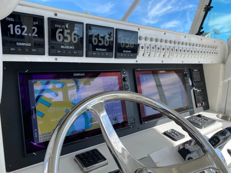 Slide: The Image of Dashboard of 2008 Everglades 355 Center Console with navigation and engine displays. - 12