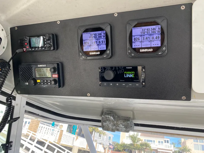 Slide: The Image of Control panel of a 2008 Everglades 355 Center Console with Simrad navigation equipment. - 13