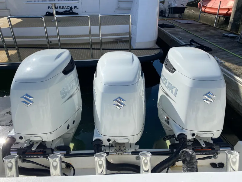 Slide: The Image of Three Suzuki outboard motors on a 2008 Everglades 355 Center Console boat. - 14