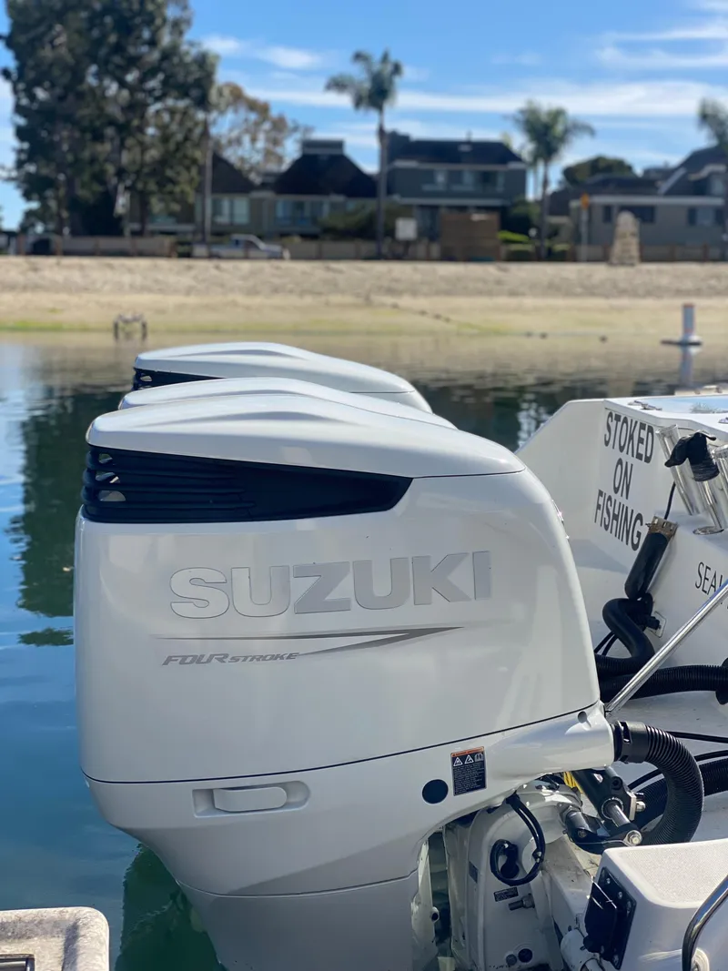 Slide: The Image of 2008 Everglades 355 Center Console with Suzuki outboard engines, docked by waterfront homes. - 15