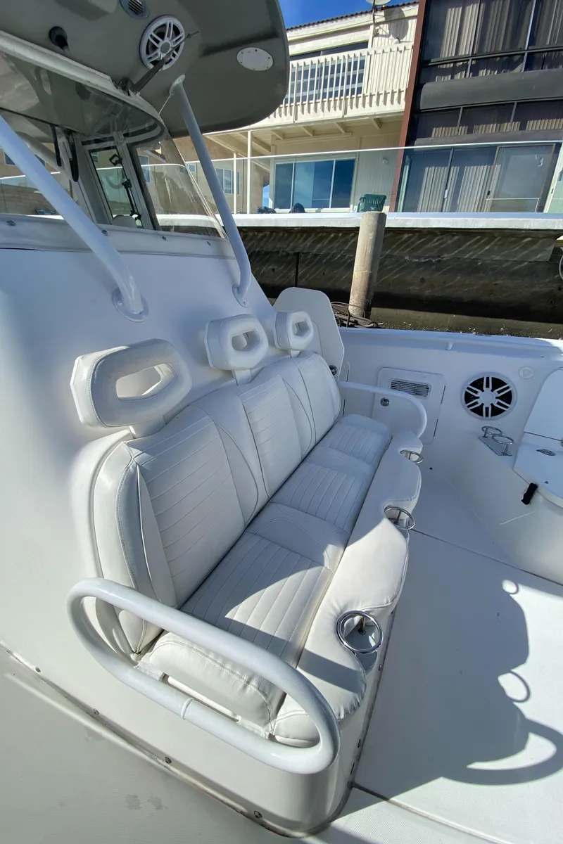 Slide: The Image of 2008 Everglades 355 Center Console boat with white seating and cup holders. - 20