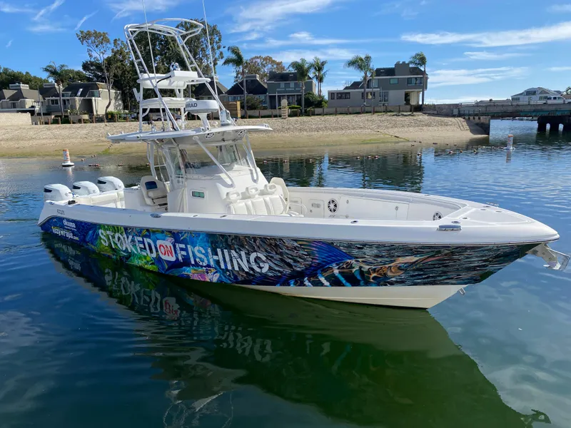 Slide: The Image of 2008 Everglades 355 Center Console boat on water, vibrant fishing-themed wrap. - 3