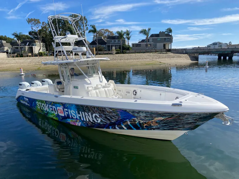 Slide: The Image of 2008 Everglades 355 Center Console boat with vibrant fishing graphics on calm water. - 4
