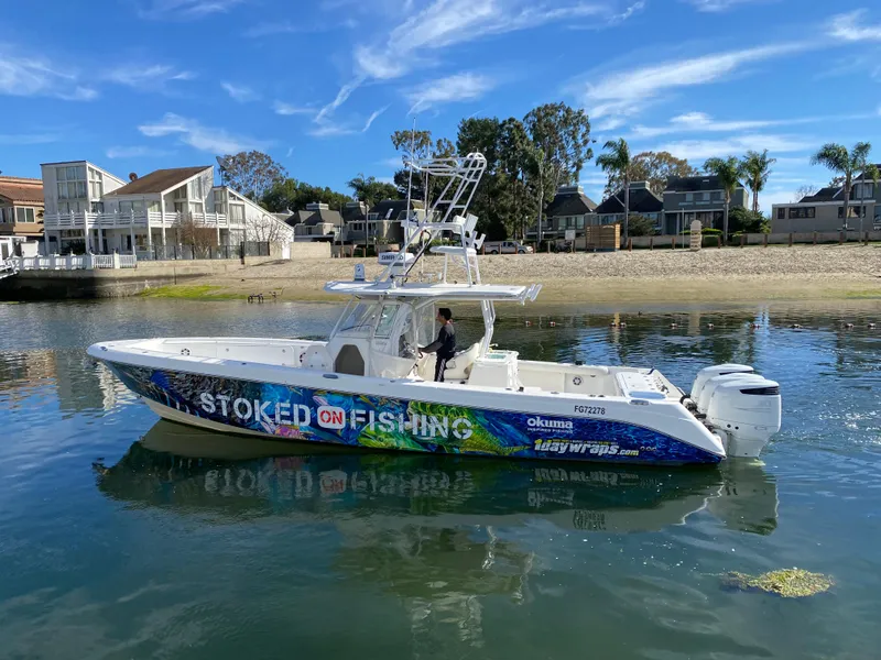 Slide: The Image of 2008 Everglades 355 Center Console boat on water, vibrant "Stoked on Fishing" design. - 9