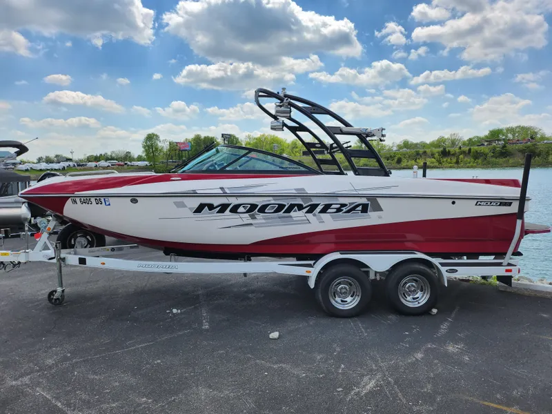 Slide: The Image of 2013 Moomba Mojo 2.5 boat on trailer by a lake under a cloudy sky. - 10