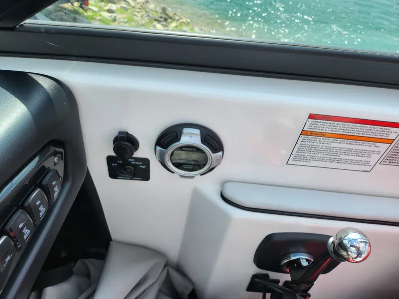 Slide: The Image of 2013 Moomba Mojo 2.5 boat dashboard with controls and water view. - 16