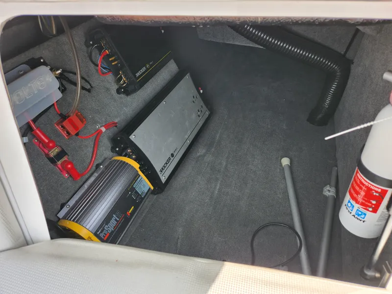 Slide: The Image of 2013 Moomba Mojo 2.5 boat interior showing electrical components and fire extinguisher. - 18