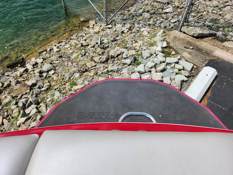 Slide: The Image of 2013 Moomba Mojo 2.5 boat at rocky shoreline, rear view. - 27