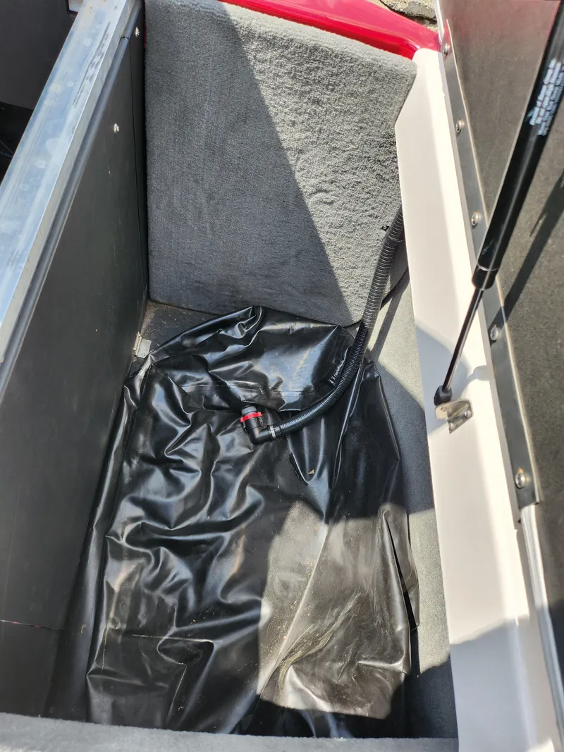 Slide: The Image of 2013 Moomba Mojo 2.5 storage compartment with black lining and hydraulic lift. - 30