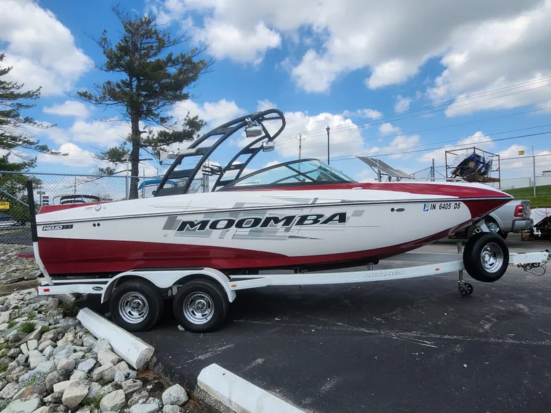 Slide: The Image of 2013 Moomba Mojo 2.5 boat on trailer, parked outdoors under blue sky. - 5