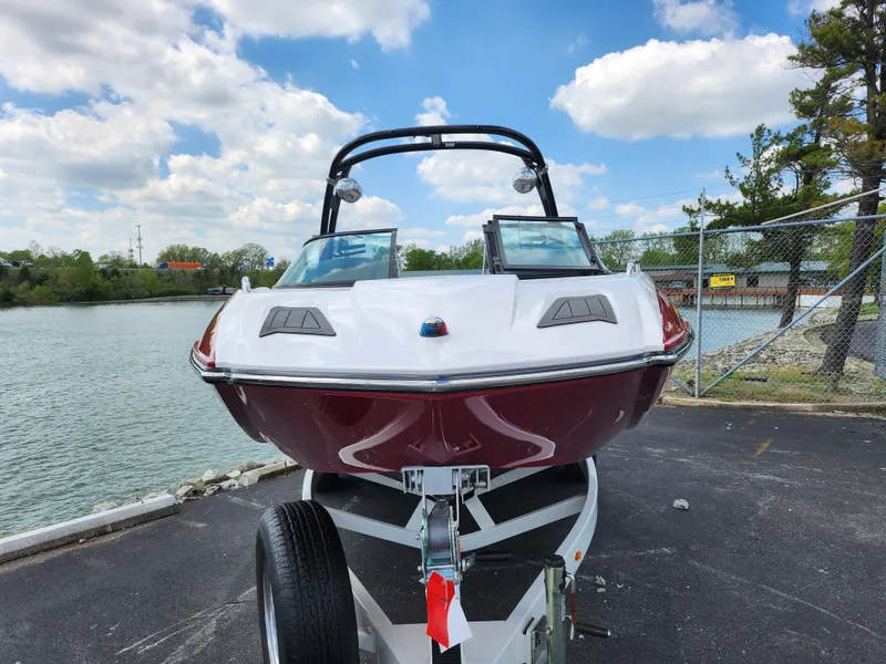 Slide: The Image of 2013 Moomba Mojo 2.5 boat on trailer by waterfront, under blue sky. - 7