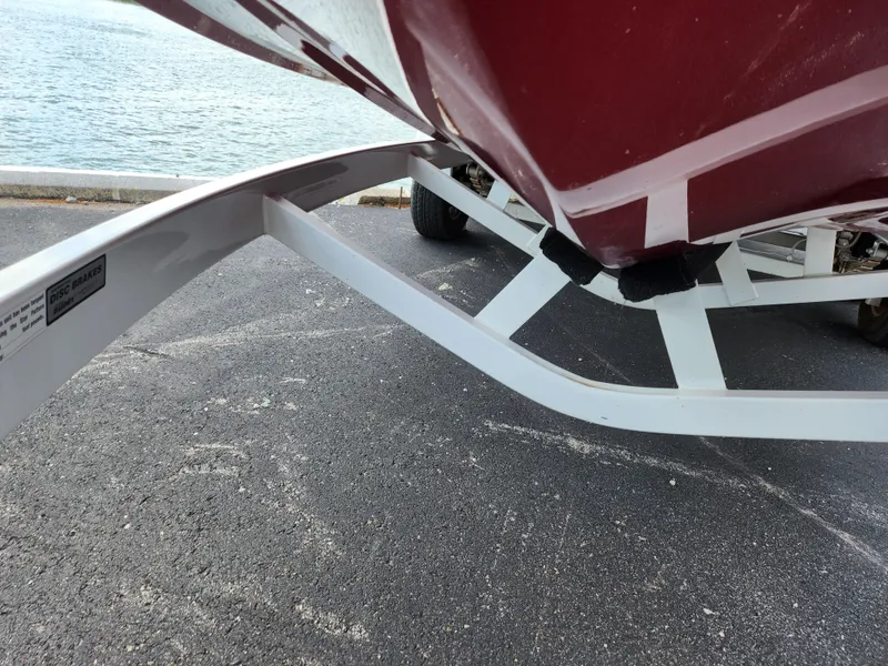 Slide: The Image of 2013 Moomba Mojo 2.5 boat on trailer near water. - 8