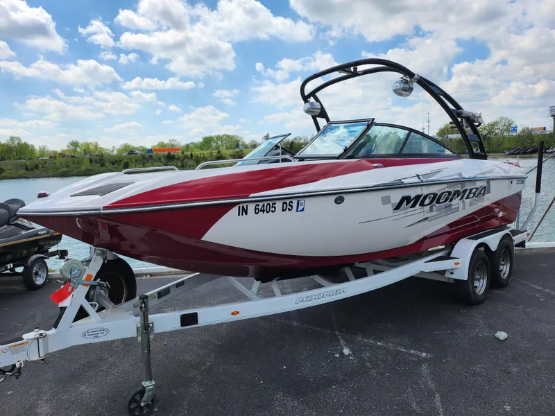 Slide: The Image of 2013 Moomba Mojo 2.5 boat on trailer by waterfront under blue sky. - 9
