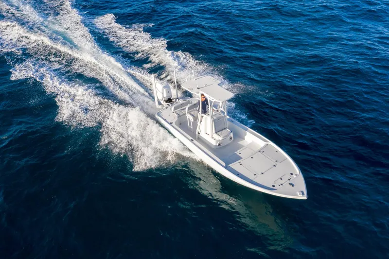 Slide: The Image of 2025 Yellowfin 24 Bay CE boat cruising on open blue water. - 10