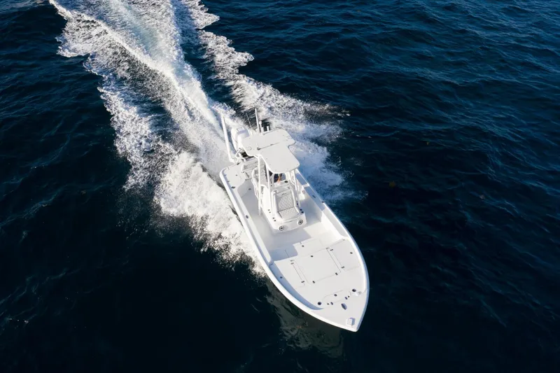 Slide: The Image of 2025 Yellowfin 24 Bay CE boat cruising on open water. - 11