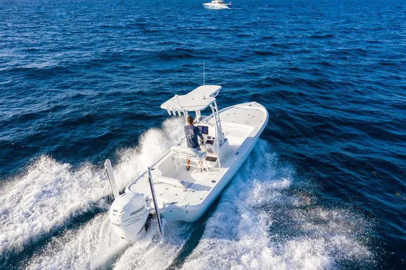 Slide: The Image of 2025 Yellowfin 24 Bay CE boat cruising on open blue water. - 14