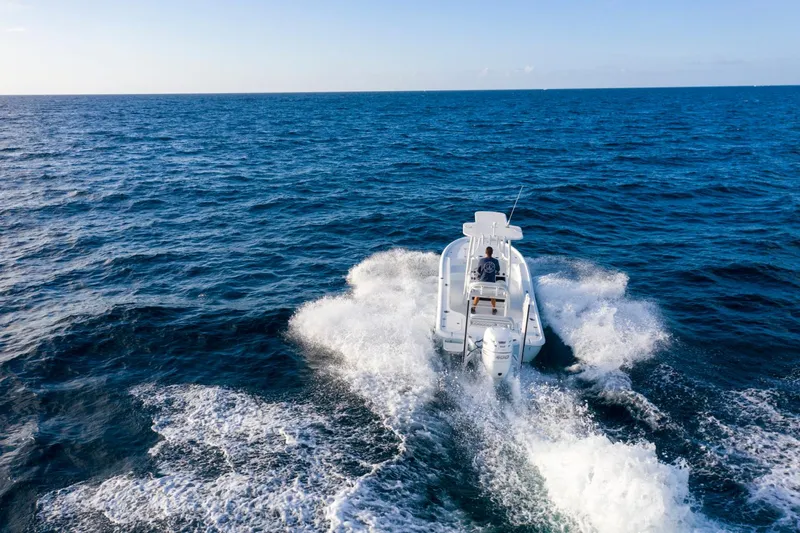 Slide: The Image of 2025 Yellowfin 24 Bay CE boat cruising on open ocean waters. - 5
