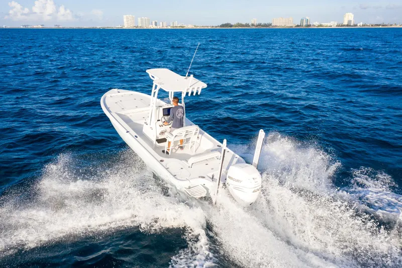 Slide: The Image of 2025 Yellowfin 24 Bay CE boat cruising on open blue ocean waters. - 6
