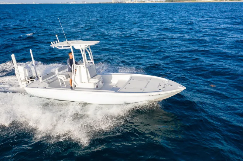 Slide: The Image of 2025 Yellowfin 24 Bay CE boat cruising on open blue ocean waters. - 9