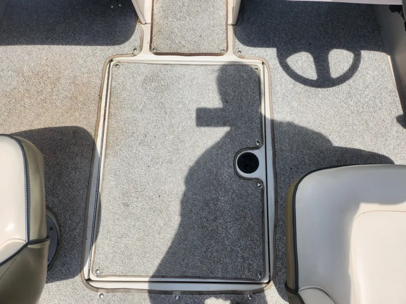 Slide: The Image of 2004 Sea Ray 200 Sport boat interior with gray carpet and seating. - 12