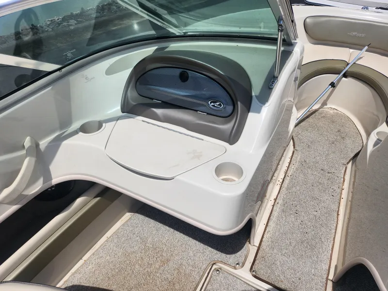Slide: The Image of 2004 Sea Ray 200 Sport boat interior with seating and storage compartments. - 13