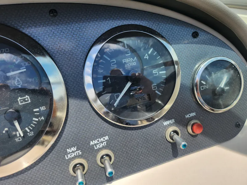 Slide: The Image of Dashboard of a 2004 Sea Ray 200 Sport boat with gauges and switches. - 15