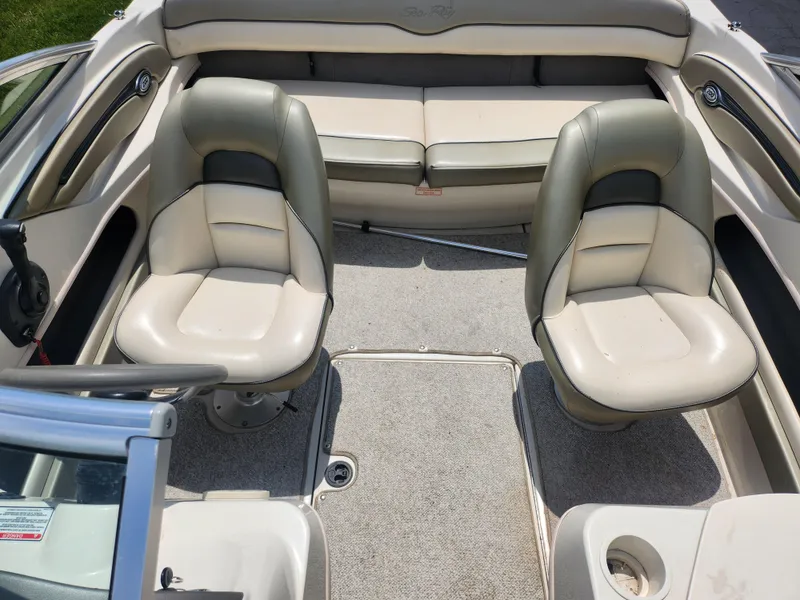 Slide: The Image of 2004 Sea Ray 200 Sport boat interior with two seats and rear bench. - 20