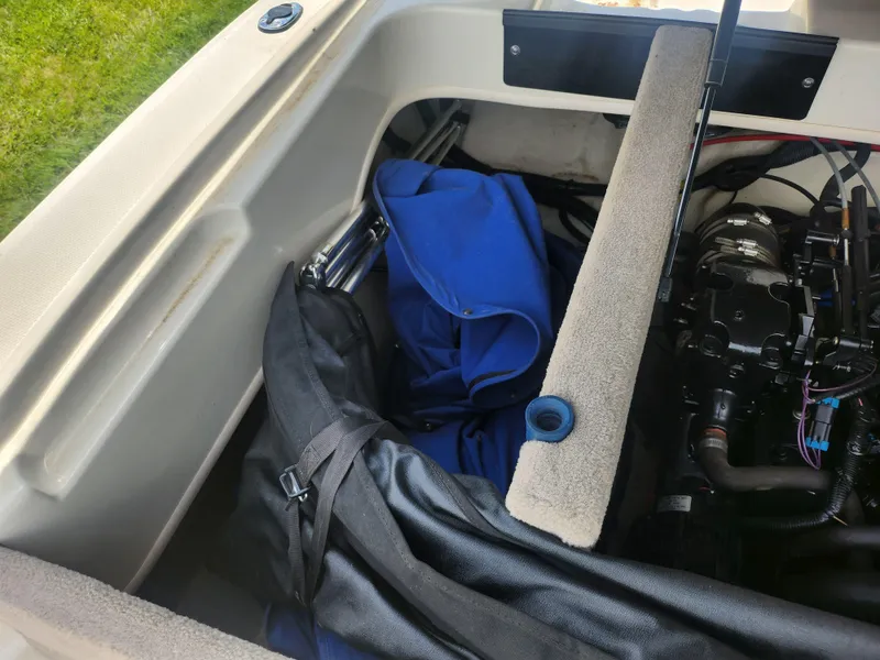 Slide: The Image of Engine compartment of a 2004 Sea Ray 200 Sport boat with storage bags. - 23