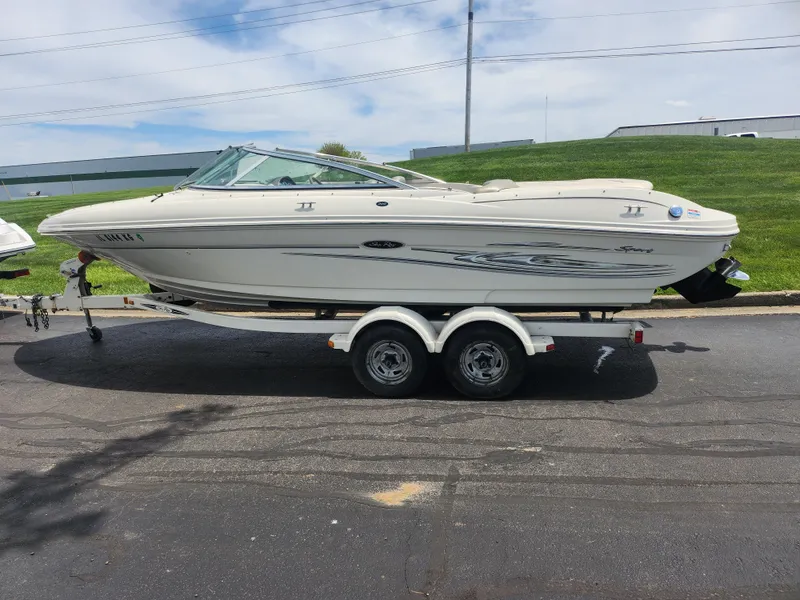 Slide: The Image of 2004 Sea Ray 200 Sport boat on trailer, parked outdoors. - 3