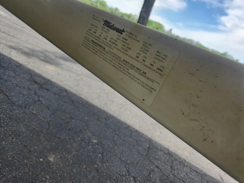 Slide: The Image of 2004 Sea Ray 200 Sport label on boat hull, Midwest manufacturer details visible. - 7