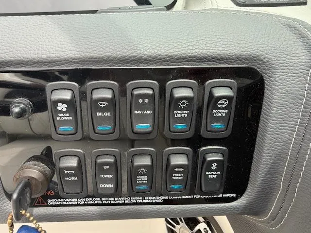 Slide: The Image of Control panel of a 2023 Regal LS6 boat with various switches and buttons. - 10