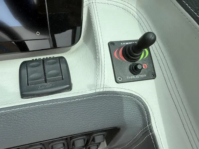 Slide: The Image of Control panel of 2023 Regal LS6 boat with joystick and buttons. - 11