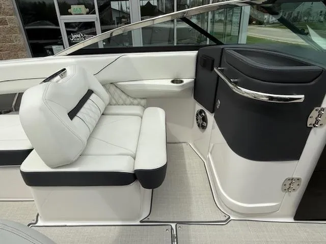Slide: The Image of 2023 Regal LS6 boat interior with white and black seating and sleek design. - 12
