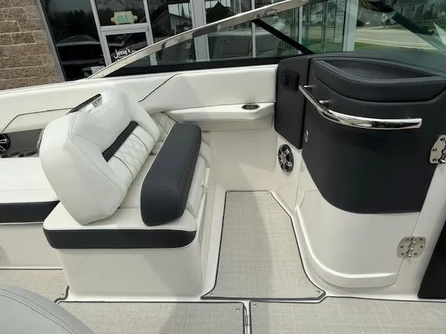 Slide: The Image of 2023 Regal LS6 boat interior with white and black seating, modern design. - 13