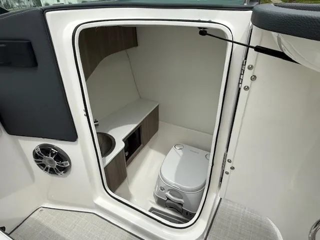 Slide: The Image of 2023 Regal LS6 boat interior with compact bathroom and modern amenities. - 15