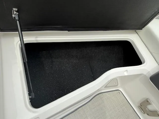 Slide: The Image of Open storage compartment in 2023 Regal LS6 boat, featuring a spacious interior. - 20