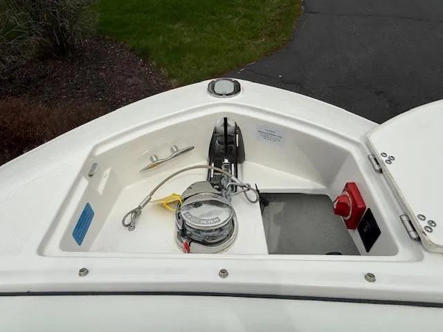 Slide: The Image of 2023 Regal LS6 boat anchor compartment with winch and control panel. - 22