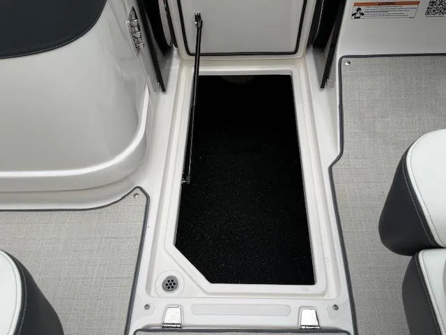 Slide: The Image of 2023 Regal LS6 boat storage compartment with open hatch and sleek interior design. - 27
